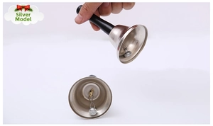 Detail view of silver hand bell showing black handle and internal metal striker