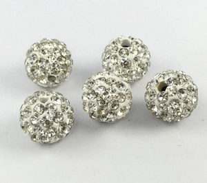 Detail view of white rhinestone clay Shamballa beads, perfect for DIY jewelry making.