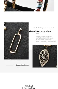 Close-up of black litchi leather bag featuring golden metal rings and pearl leaf pendant