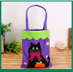 Detail of purple felt Halloween candy bag featuring black cat and pumpkin applique