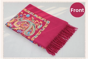Detail of rose red wool shawl with intricate paisley embroidery and fringed edges