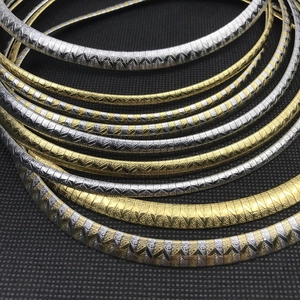 Macro detail of 4mm and 6mm stainless steel omega chains with chevron textures