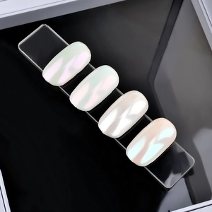 Clear acrylic nail display bar with four oval iridescent pearl tips in high contrast