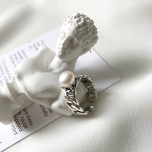 Detail of vintage sterling silver Cuban chain ring featuring a large white pearl inlay