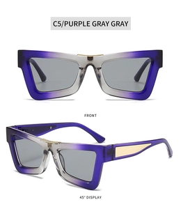 Detail view of purple gray cat-eye sunglasses with gold braided bridge and side accents