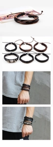 Close-up of multilayer braided leather bracelets with vintage metal plates on wrist