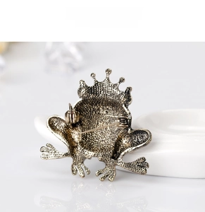 Detail view of the vintage frog prince brooch showing metal texture and pin closure