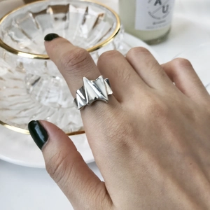 Close-up of geometric zigzag S925 sterling silver ring on hand with elegant aesthetic