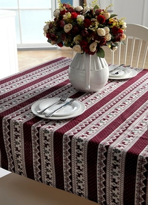 Close-up of festive red Christmas tablecloth with reindeer and snowflake knit patterns