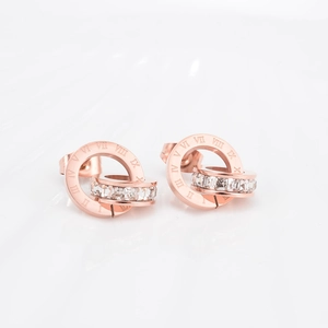 Detail of rose gold double rings earrings with Roman numerals and cubic zirconia