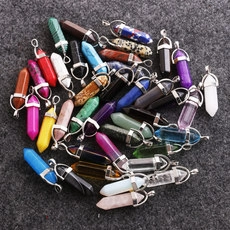 Close-up of various hexagonal bullet stone crystal pendants in multiple vibrant colors