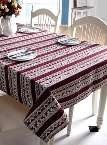 Detail of Christmas tablecloth featuring red reindeer and snowflake prints on linen fabric