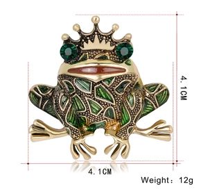 Macro view of frog crown brooch with green enamel, measuring 4.1cm by 4.1cm