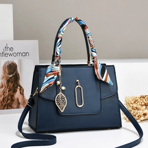 Navy blue pebble leather handbag with silk scarf handle and golden leaf pendant charm