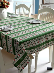 Festive Christmas tablecloth featuring red reindeer and snowflakes on a green fabric