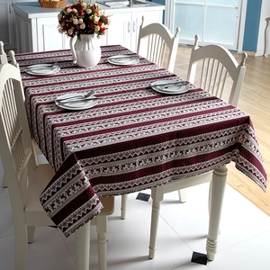 Festive red and white Christmas tablecloth with reindeer patterns in a cozy dining room