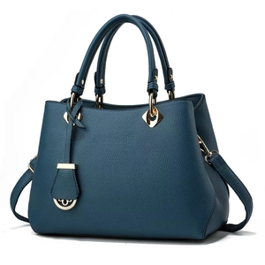 Classic dark blue pebbled leather handbag with gold hardware and detachable strap