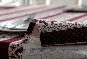 Macro detail of Nordic Christmas table runner with reindeer and snowflake woven patterns