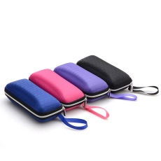Four colorful zippered sunglasses cases with honeycomb texture and wrist straps on white back