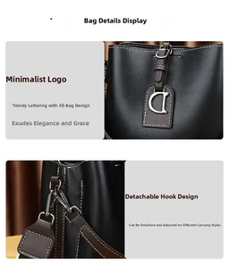 Détails d'un sac seau noir avec surpiqûres blanches et pendentif métallique en forme de D