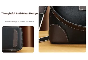 Détail du sac en cuir bicolore avec pieds de protection et surpiqûres contrastées