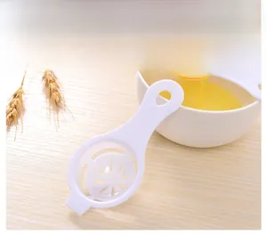 Close-up of a white plastic egg separator with hollow petal base on a wooden table