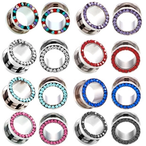 Macro view of multi-color screw-fit steel ear gauges with sparkling rhinestone borders