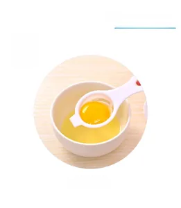 White PP egg separator with long handle shown filtering egg yolk over a white bowl