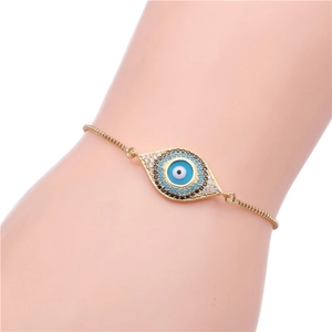 Detail of adjustable evil eye bracelet with cubic zirconia on a model's wrist