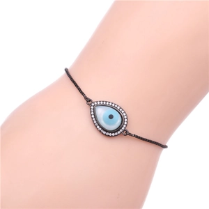 Detailed view of evil eye teardrop charm bracelet with cubic zirconia on black chain