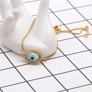 Detail of adjustable evil eye teardrop bracelet with cubic zirconia and gold box chain