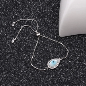 Close-up of evil eye drop bracelet with sparkling crystals and adjustable slider clasp
