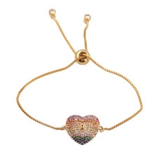 Close-up of golden heart bracelet with rainbow zircon stones and adjustable slider clasp