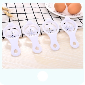 Detailed view of four white plastic egg white separators with hanging hole design