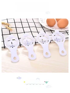 Set of 4 white plastic egg yolk separators with petal-shaped holes in a kitchen setting