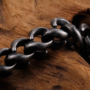 Rugged men's titanium steel chain bracelet in vintage silver finish on wood background