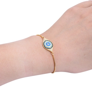 Macro detail of adjustable golden Evil Eye bracelet with blue micro zircon inlay