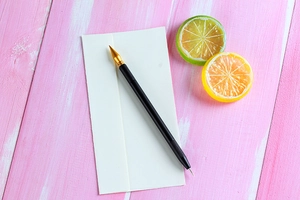 Close-up of black matte dual-purpose scratch art pen with sharp golden metallic tip