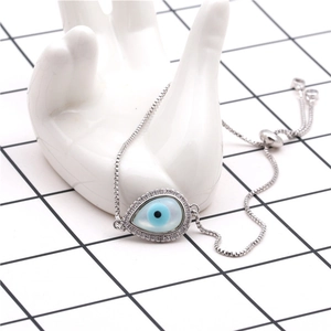 Macro detail of Evil Eye teardrop pendant with blue stone and adjustable box chain