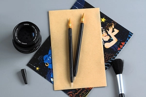Close-up of dual-ended scratch tools with anti-slip black metal handles and gold tips