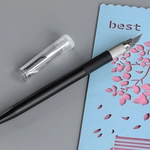 Detail view of cloud-shaped utility knife with sharp blade and replacement tube