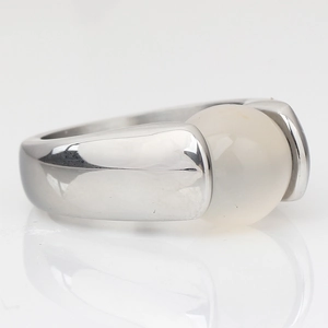 Macro side view of silver stainless steel ring with 10mm round white cat's eye stone