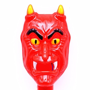 Close-up of a red glowing devil head wand with yellow horns for Halloween party decor