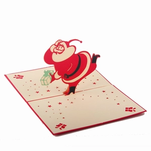 3D pop-up Christmas greeting card featuring a dynamic Santa Claus in red and white