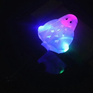Glow-in-the-dark Halloween wand in ghost shape with vibrant blue and pink LED lights