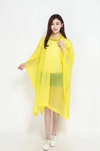 Close-up of yellow translucent rain poncho with drawstring hood and side snap buttons