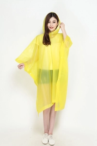 Detail of yellow adult hooded poncho raincoat with snap buttons in waterproof material
