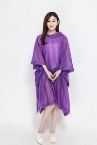 Front view of a model wearing a purple translucent hooded poncho for outdoor cycling