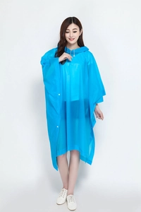 Detail of blue waterproof hooded rain poncho with front snap buttons and drawstring