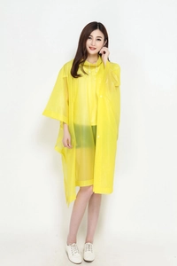 Close-up of yellow translucent rain poncho with drawstring hood and snap button details
